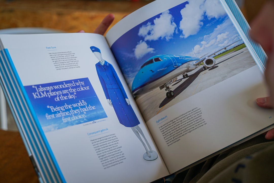 A person reading a Klm book